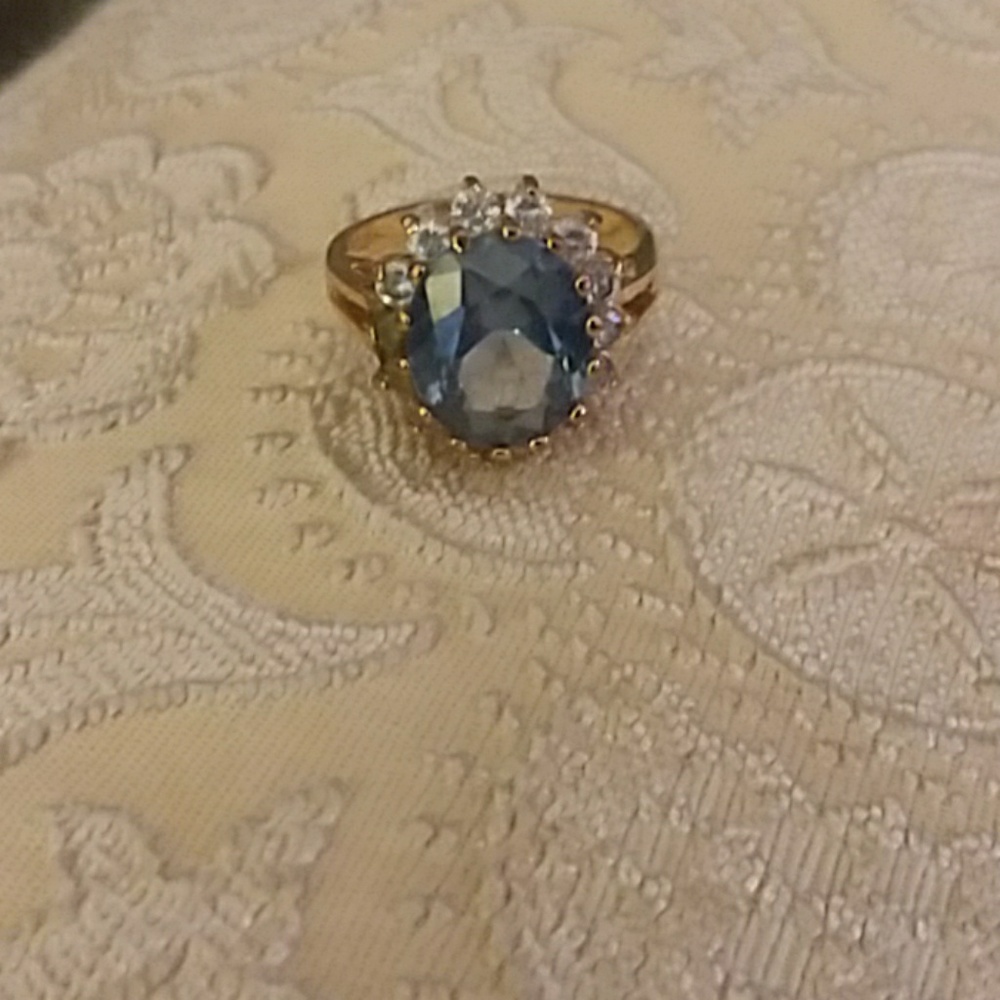 Ring blue stone. Gold setting with rhinestones
